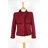 A Chanel raspberry boucle jacket
with black and red trim, with four logo buttons to the front, round