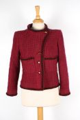 A Chanel raspberry boucle jacketwith black and red trim, with four logo buttons to the front, round