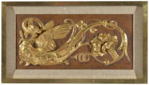 A carved and painted decorative panelof rectangular form depicting a winged mythical