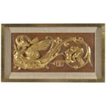 A carved and painted decorative panel
of rectangular form depicting a winged mythical