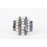 A large 18ct white gold, sapphire and diamond cluster dress ring
set with four rows of sapphires