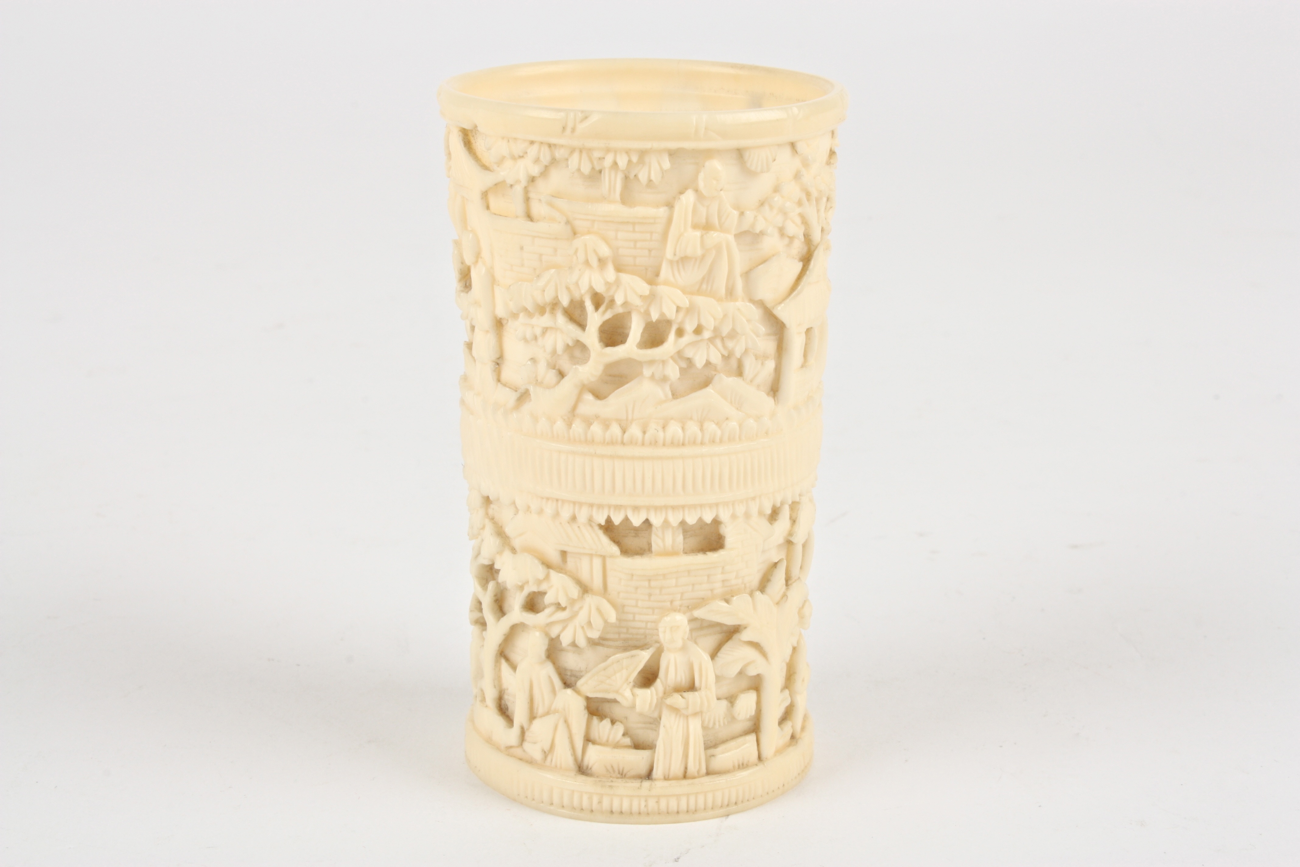 A late 19th / early 20th Chinese Canton carved ivory dice cup
decorated with two bands of scenes