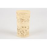 A late 19th / early 20th Chinese Canton carved ivory dice cup
decorated with two bands of scenes