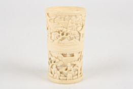 A late 19th / early 20th Chinese Canton carved ivory dice cupdecorated with two bands of scenes