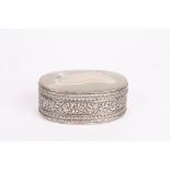 A variegated agate trinket box
of oval form in chased and repoussé silver coloured metal