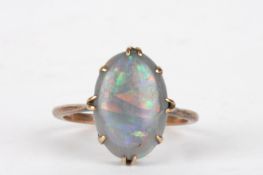 A 9ct gold and opal ringthe oval opal in an eight claw plain setting.Dimensions: Size N.Condition