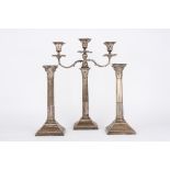 A pair of George V silver Corinthian column candlesticks and a matched Edwardian candelabra,