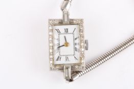 A ladies Art deco style diamond cocktail watchthe white rectangular shaped dial surrounded by small