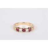 A 9ct gold, ruby and diamond five stone ring, set with three rubies interspersed with two