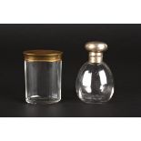 A silver topped glass scent bottle
hallmarked Birmingham 1925, together with a brass topped dressing