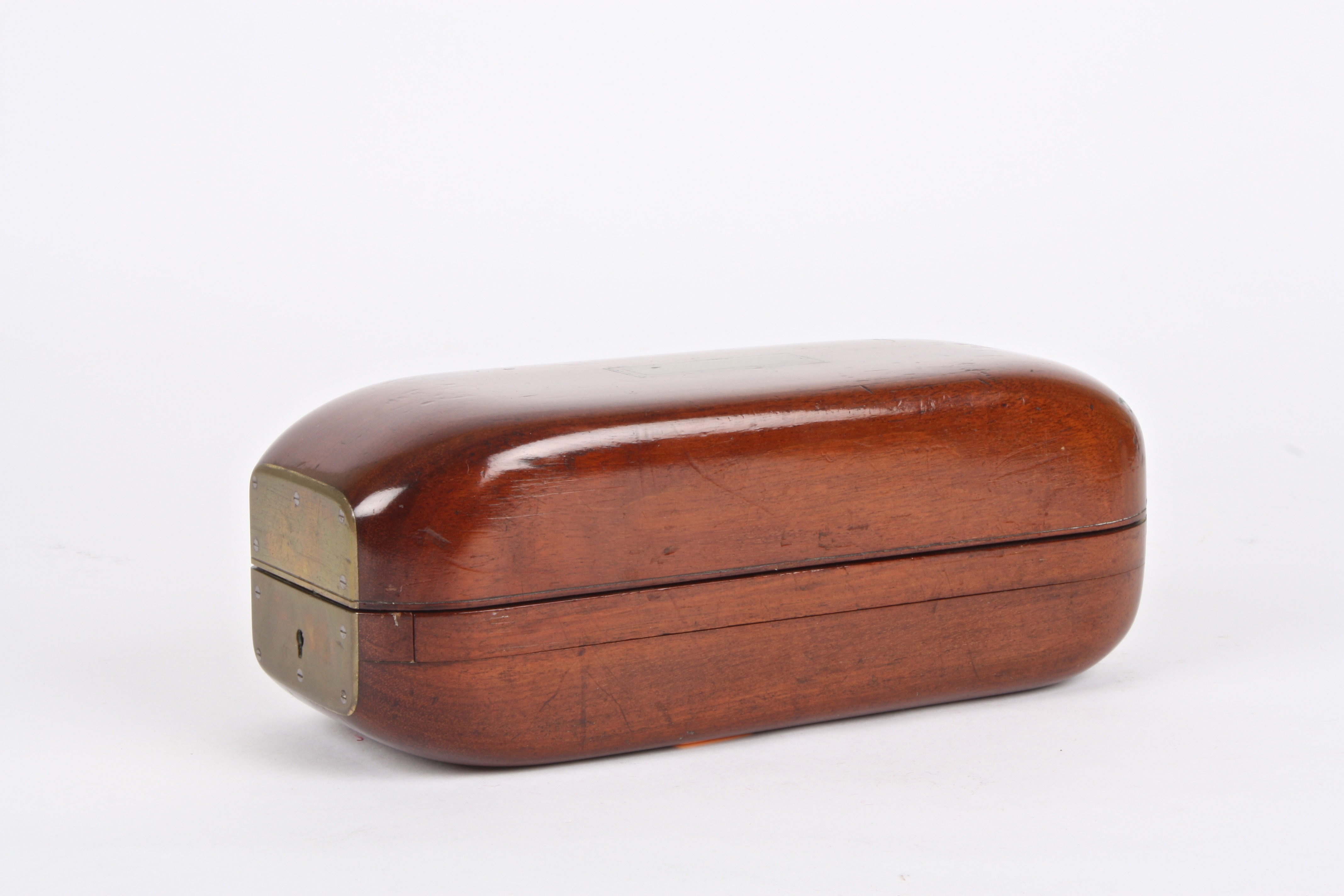 A gentleman's unusual 19th century mahogany cased travelling shaving set
the case of unusual shape