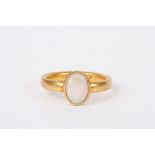 A 22ct gold and opal ring
with Birmingham hallmark, with rubover setting and plain shank.Dimensions: