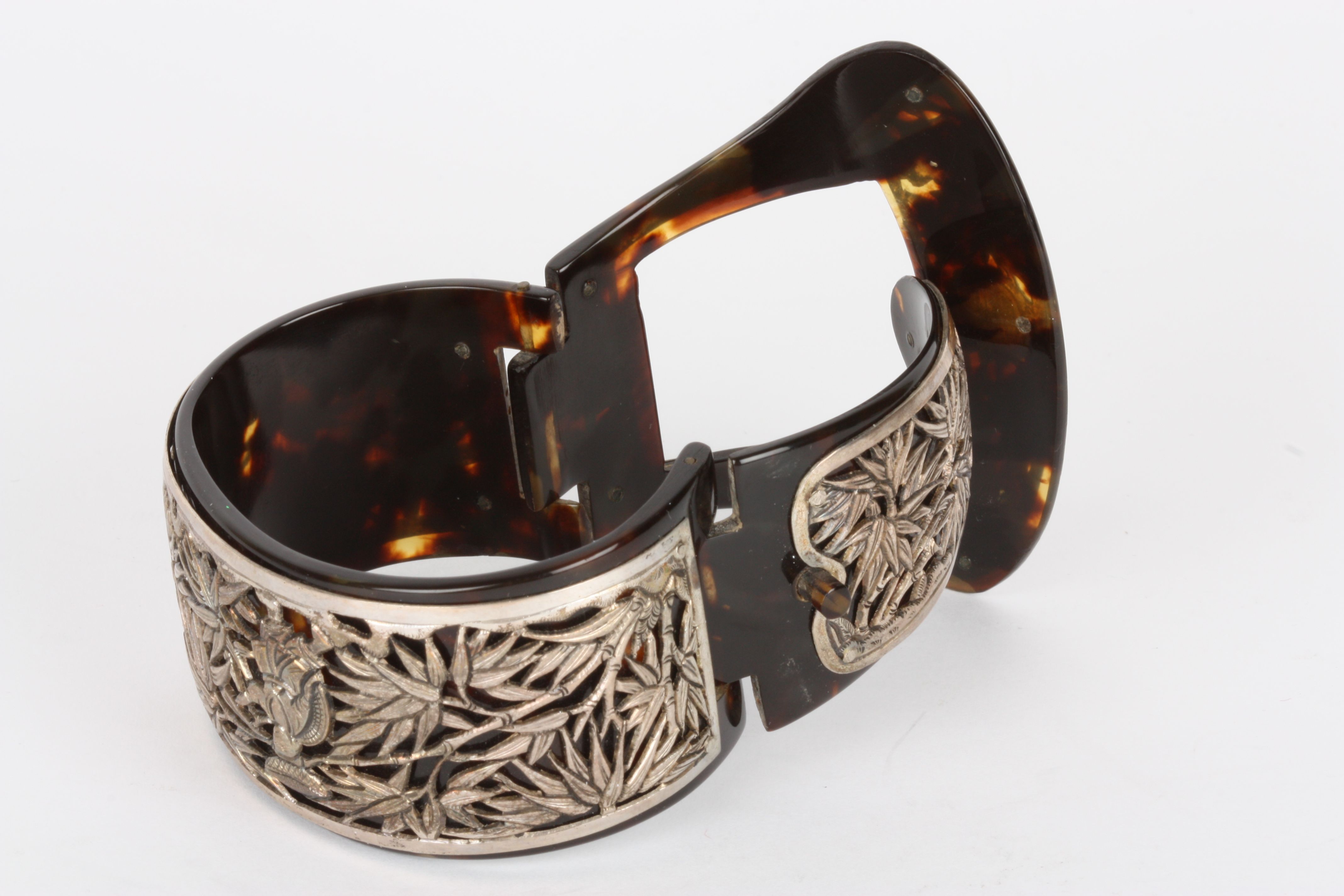 An early 20th century Oriental tortoiseshell and white metal bangle
with hinged clasp of buckle - Image 2 of 2