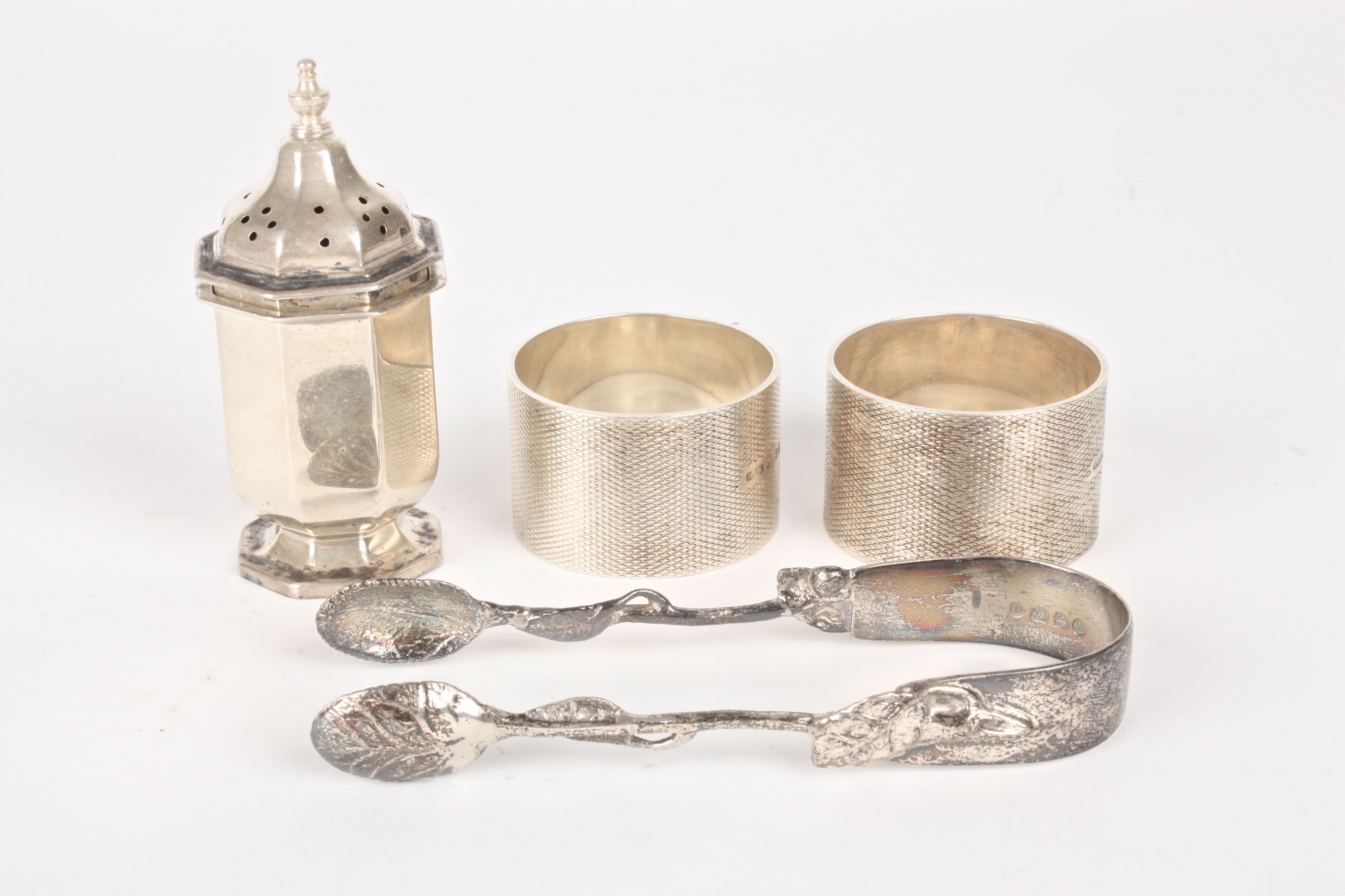 Two silver napkin rings
hallmarked Birmingham 1930 with engine turned decoration and cartouches