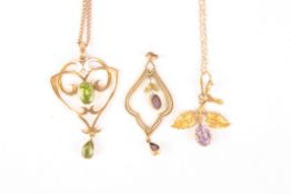 An Edwardian 9ct gold and peridot scrolled pendant on chaintogether with a 15ct gold and amethyst