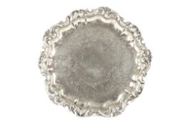 A silver plated trayof pie-crust form, decorated with scrolls and foliageDimensions: diameter