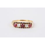 An 18ct gold, ruby and diamond five stone ring
set with three rubies interspersed by two diamonds,