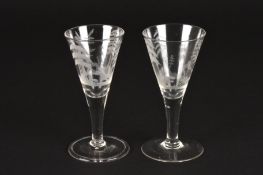 A pair of late 18th century engraved hunting drinking glassesone decorated with a bear hunting
