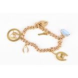A 9ct gold charm bracelet
set with five charms and a padlock clasp.Dimensions: 36.2 grams total.