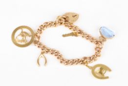 A 9ct gold charm braceletset with five charms and a padlock clasp.Dimensions: 36.2 grams total.