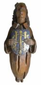 A carved and painted figureheadprobably lime wood, the crowned figure holding a shield with gilt