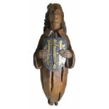 A carved and painted figurehead
probably lime wood, the crowned figure holding a shield with gilt