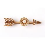 A Victorian diamond and seed pearl bar brooch
in the form of an arrow, the shaft set with a pearl