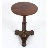 An early 19th century mahogany wine table
the plain circular top supported on a tapering carved