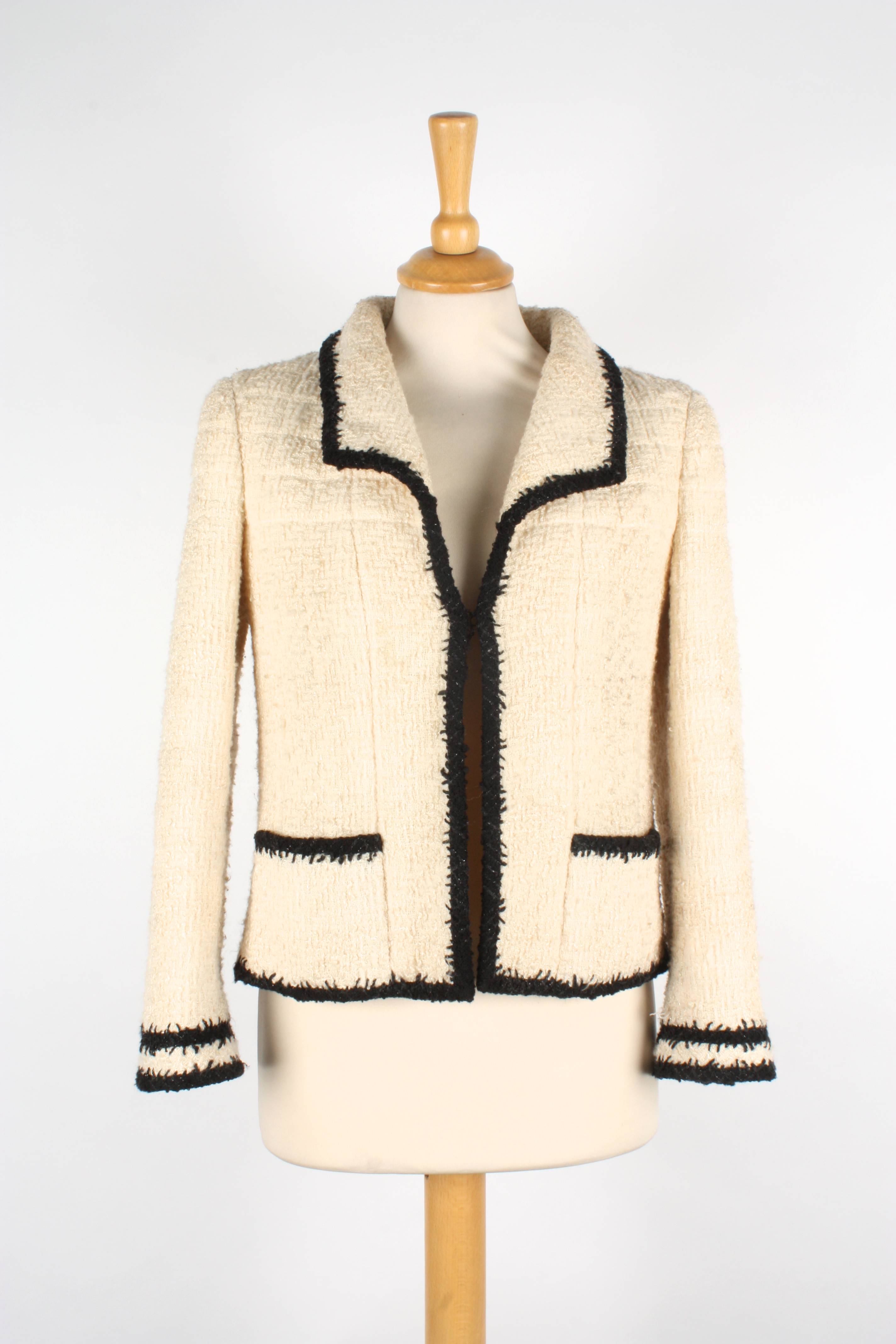 Two Chanel boucle jackets. The first cream jacket with black trim, two ...