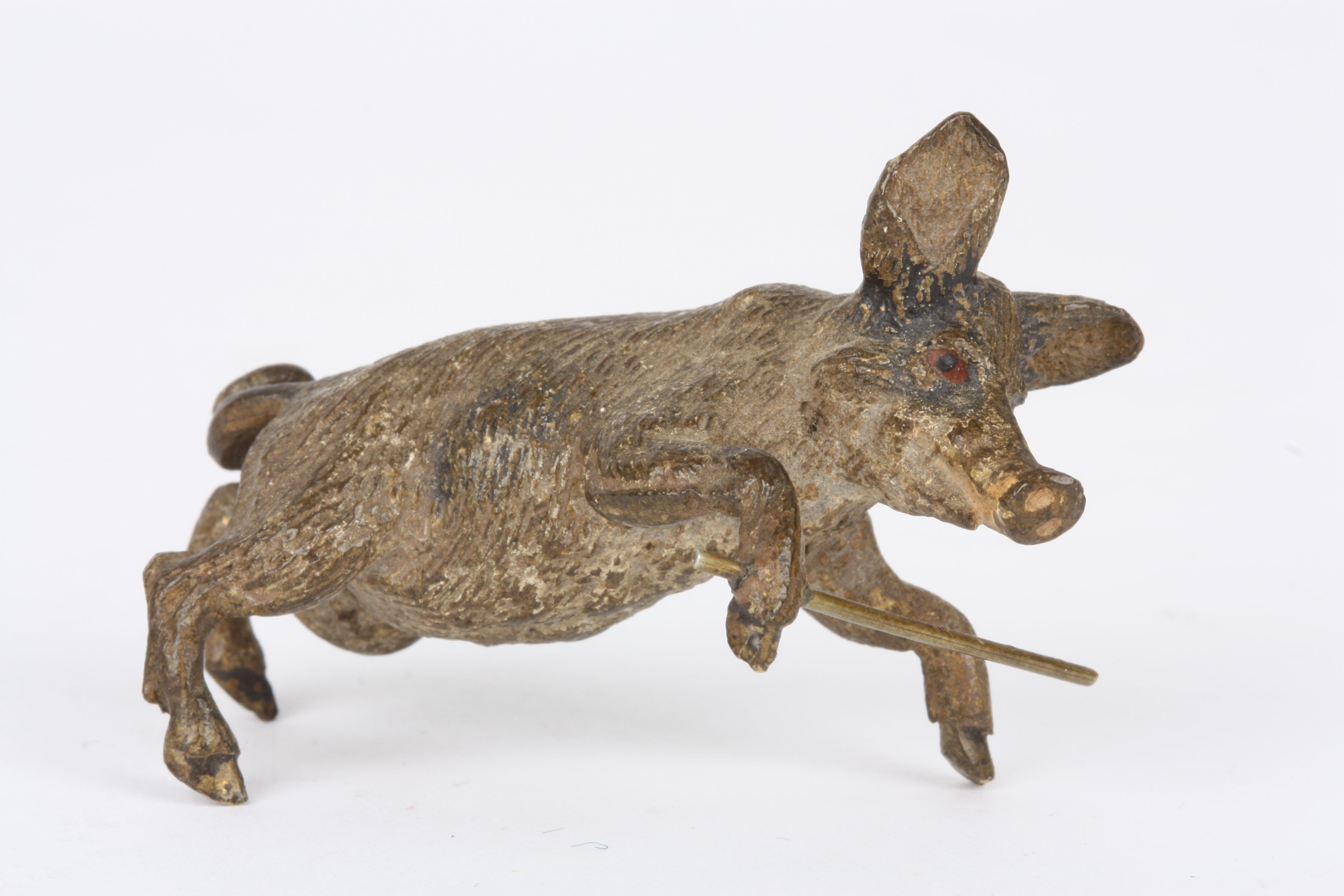 An early 20th century Austrian cold painted bronze pig
in a standing pose and holding a stick,