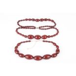 Two cherry amber coloured necklaces
the first single strand graduated oblong beads on modern