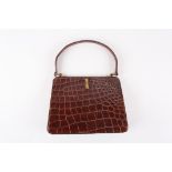 A 1930's crocodile handbag
of slightly tapered form, the brown coloured bag with gold coloured
