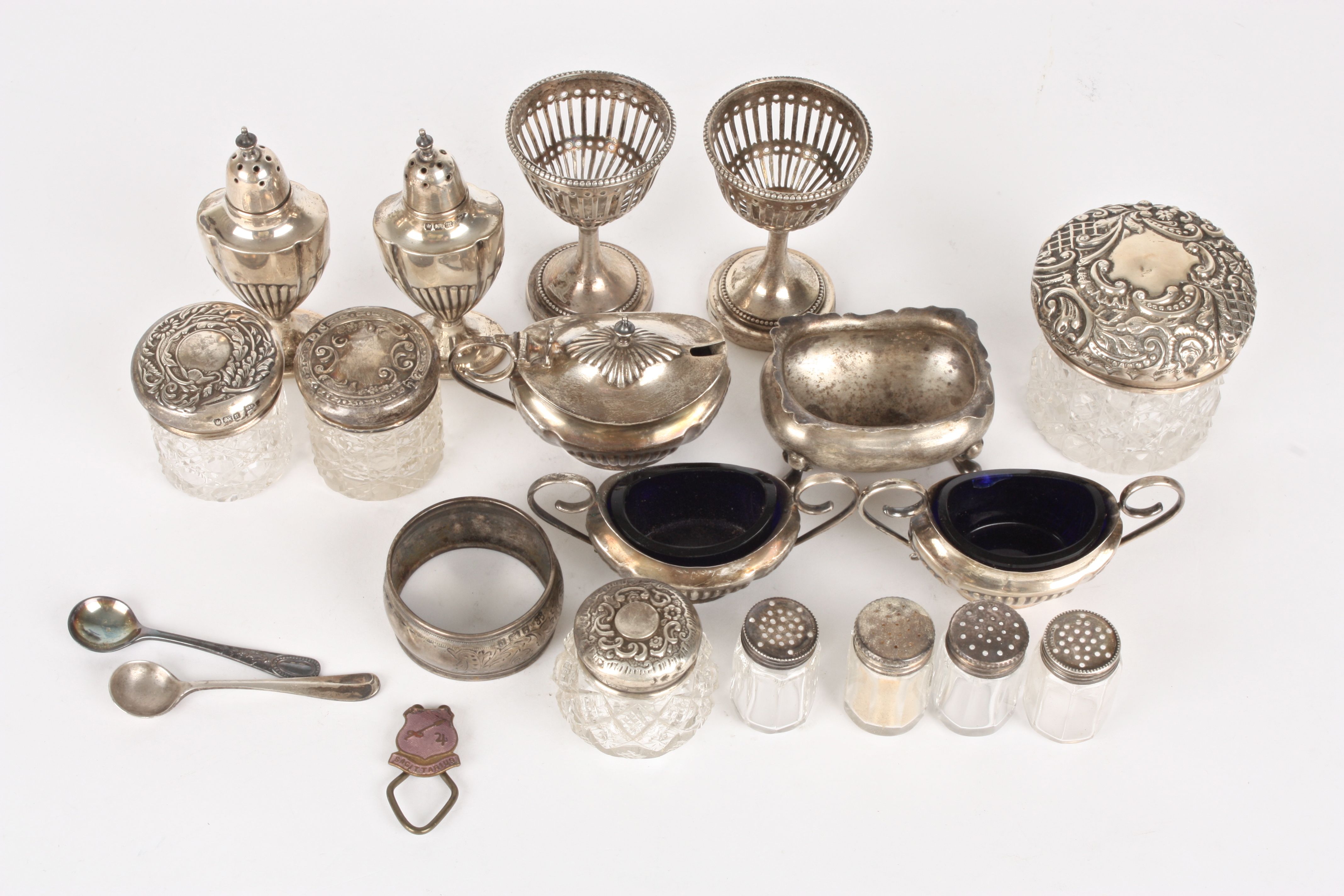 A collection of silver
comprising predominantly tableware including pepperettes, salts, mustard pot,