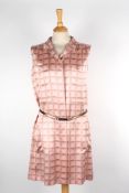 A Chanel silk shirt sleeveless dressthe pale pink dress with printed logos throughout, and matching