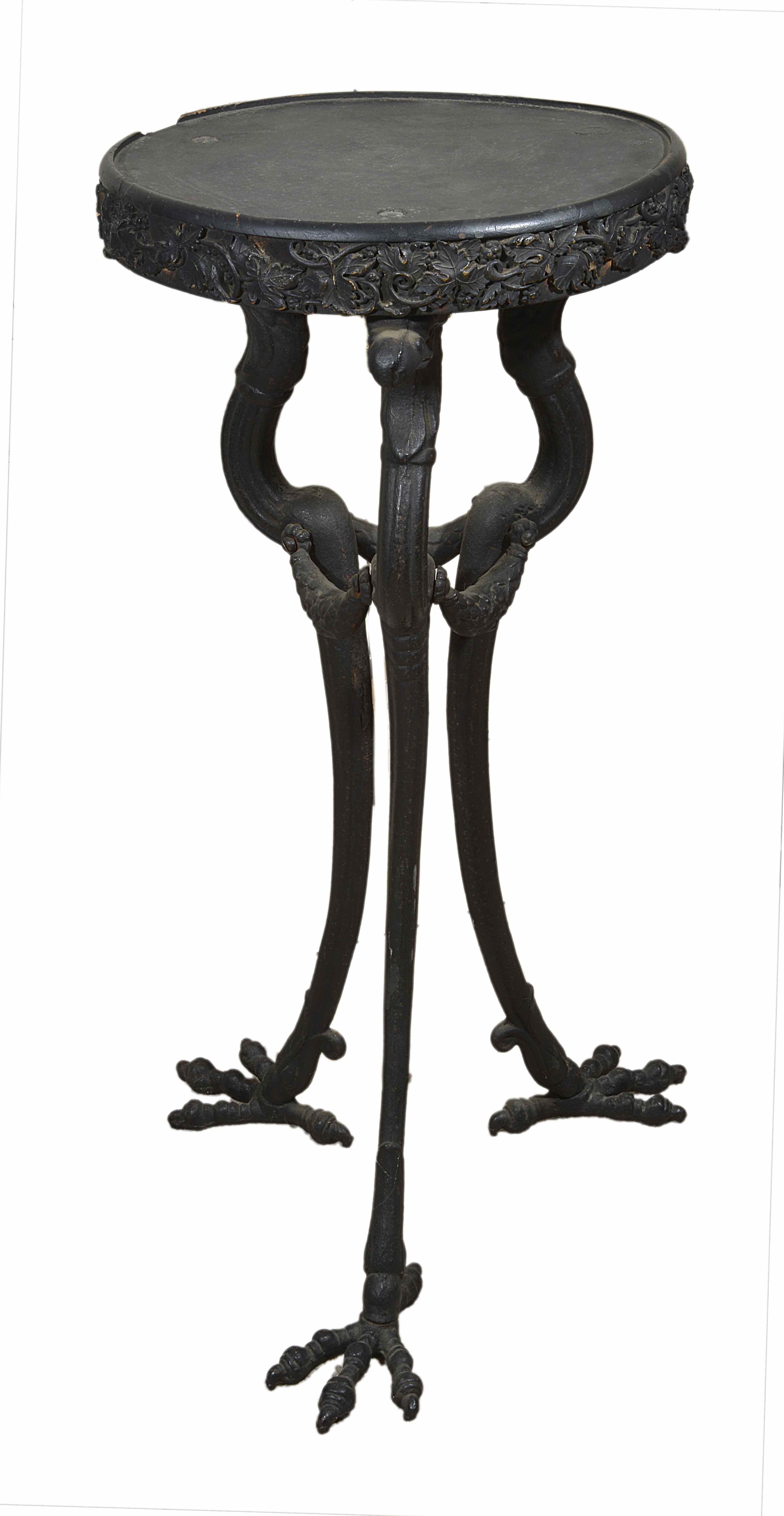 A late 19th/early 20th century cast iron tripod stand
the wooden circular top with a cast band