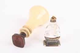 An ivory handled seal with screw fitting, together with a white metal and glass seal with handle