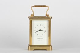 A 20th century Garrard & Co. brass carriage clockwith white dial and black Roman numerals, the dial