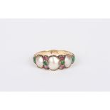 A 19th century mother of pearl, tourmaline and emerald ring of suffragette colours
set with three