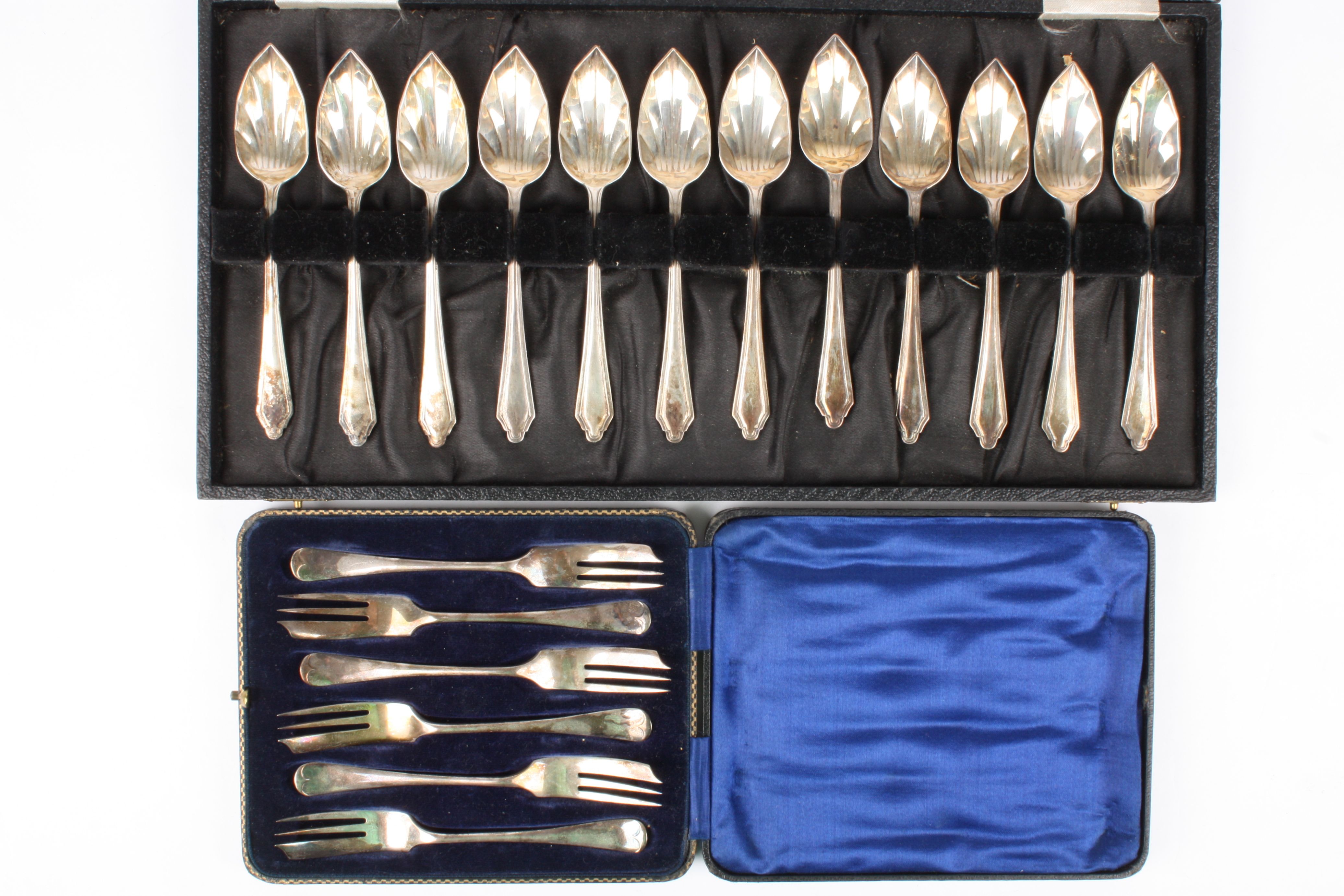A cased set of twelve George V silver grapefruit spoons
hallmarked Birmingham 1933; together with
