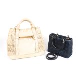 Two designer bags
the first a navy denim Christian Dior small bag with detachable long strap,