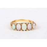 An 18ct gold, opal and diamond five stone ring
the five oval opals interspersed with diamond points,