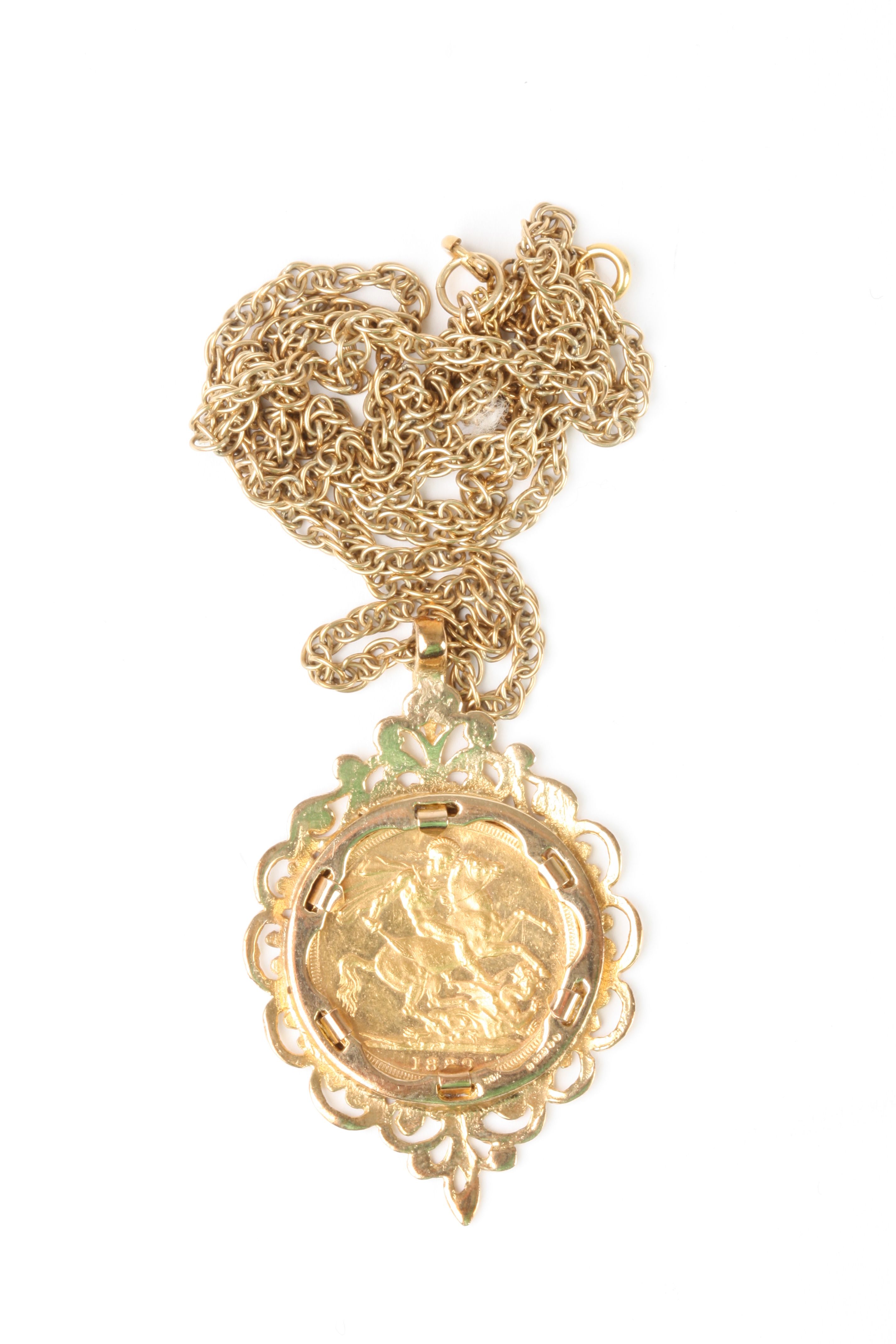 A Victorian 1889 22ct gold full sovereign
in an ornate foliate 9ct gold mount, on a 9ct gold chain.