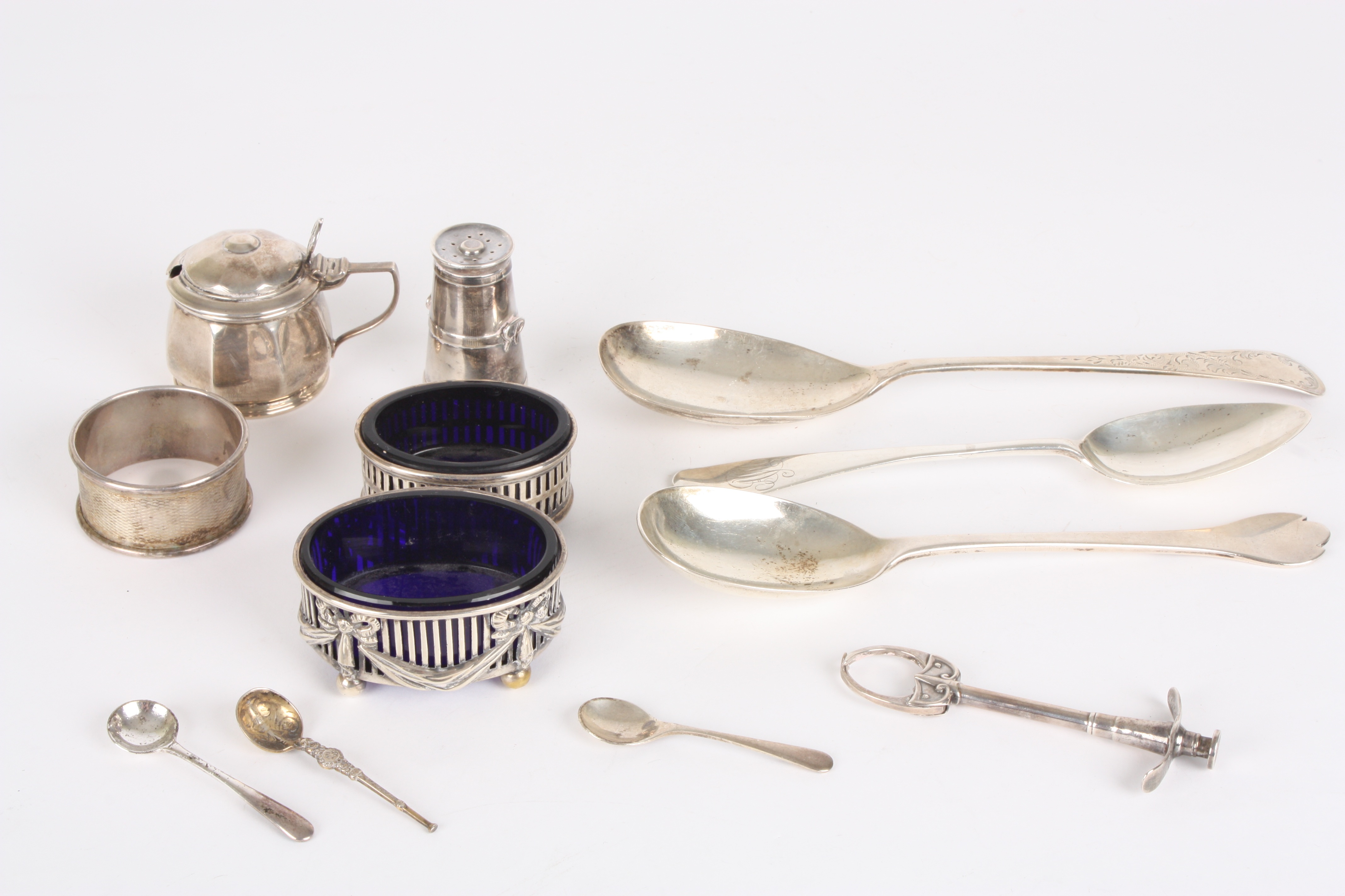 A collection of assorted silverware
including a matched silver cruet set with blue glass liners, a