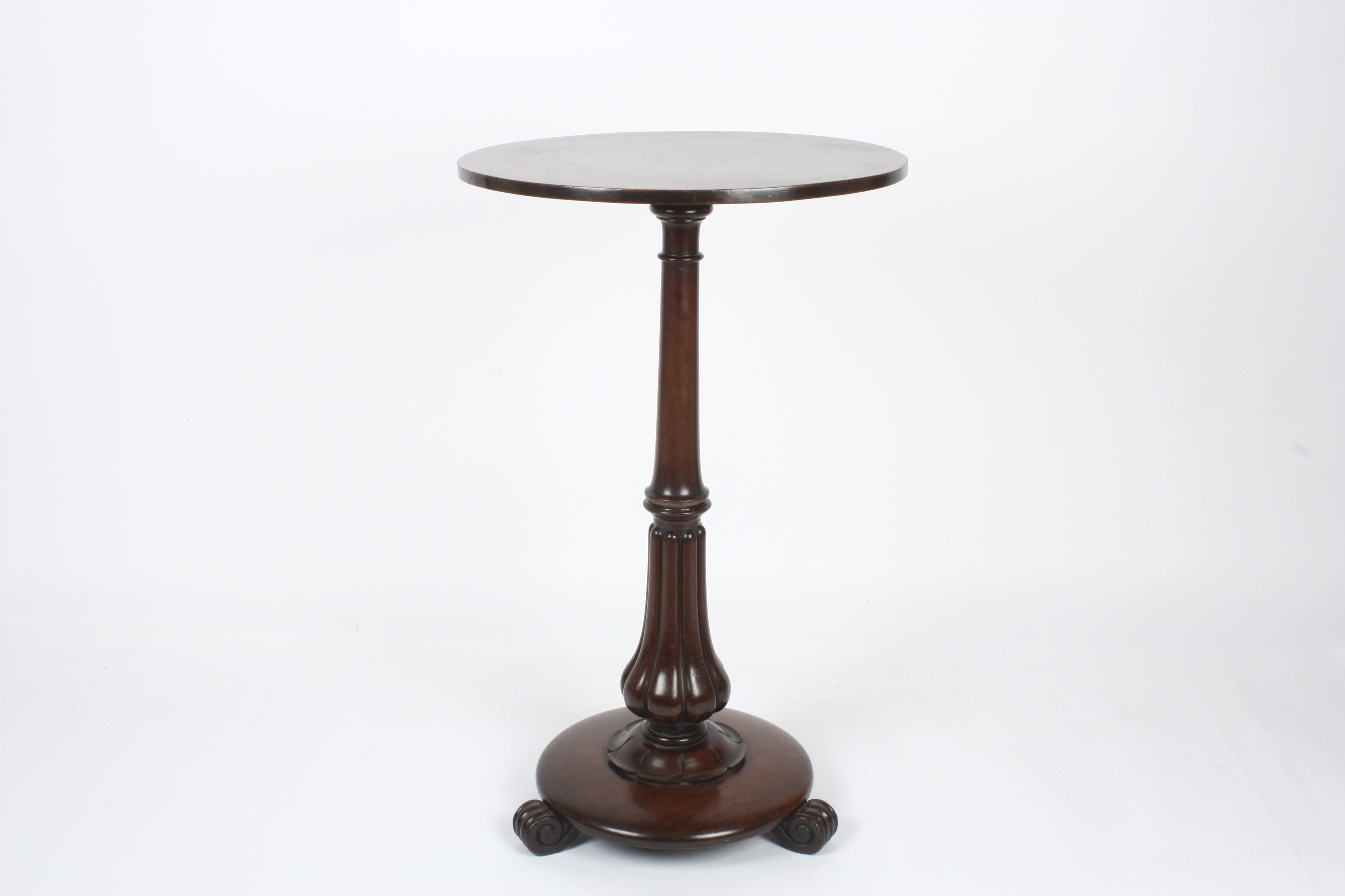 A Regency mahogany wine table
the plain circular top supported on a tapered column, with fluted