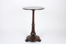 A Regency mahogany wine tablethe plain circular top supported on a tapered column, with fluted