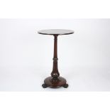 A Regency mahogany wine table
the plain circular top supported on a tapered column, with fluted