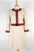 A cream Chanel wool skirt suitthe jacket with round neck and black and red trim to edges and cuffs,
