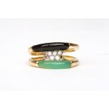A modern diamond, onyx and jade ring
set in 18ct yellow gold, in a split shank design, Size P.