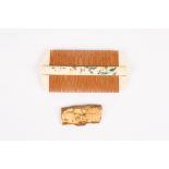 A Japanese painted bone two sided comb
decorated with a landscape scene and character marks verso,