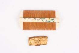 A Japanese painted bone two sided combdecorated with a landscape scene and character marks verso,